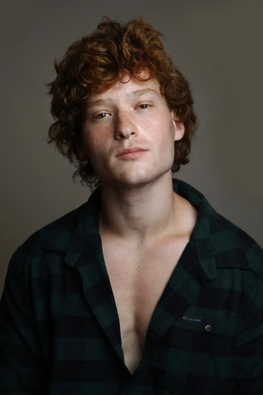 Nimrod Endvelt portrait in a dark green plaid shirt
