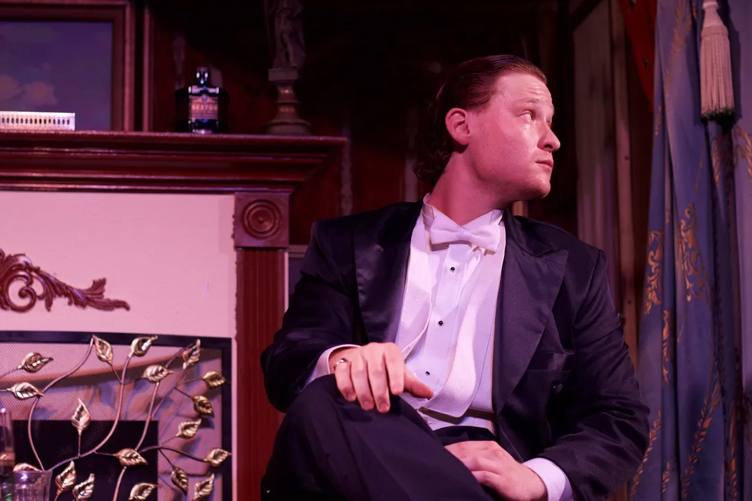 Nimrod Endvelt as Arthur Birling looking toward another character